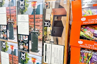 gas fire pit with sliding table next to a gas patio heater