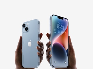 Two hands holding iphones
