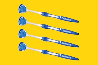 Four DenTek Orabrush Tongue Scrapers sit in a row on a yellow background.