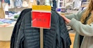 A person shopping for winter coats at GAP
