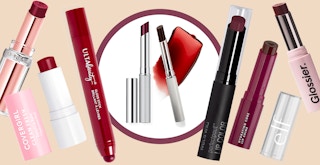 Clinique almost lipstick in black honey surrounded by different brands of lipstick and gloss that are dupes