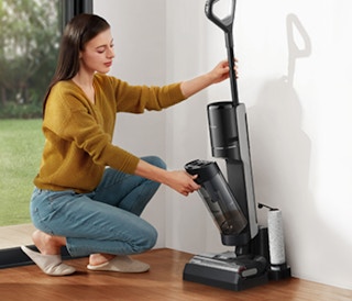 a woman emptying out a vacuum
