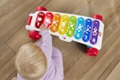 a baby playing with a musical toy