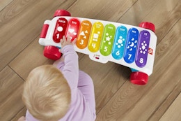 a baby playing with a musical toy