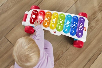 a baby playing with a musical toy