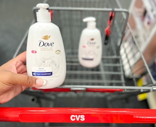 hand holding bottle of Dove hand soap in front of cart with another bottle inside