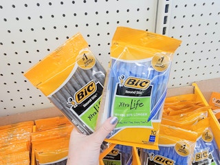 hand holding packs of black and blue pic pens