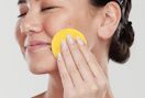 a person using a turmeric cleansing pad on their face
