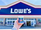 someone holding a paint sample outside of lowes