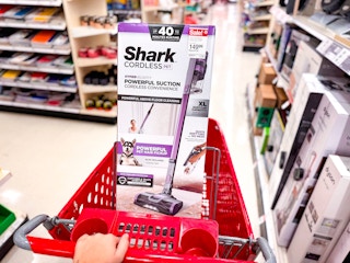 shark pet cordless stick vacuum sitting on a target cart