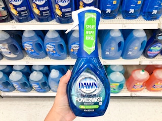 hand holding bottle of Dawn in front of store soap display