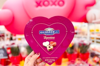 Ghiradaelli Heart Box of chocolates held up in front of "xoxo" Valentine's day display at Target