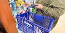 someone shopping at Walgreens carrying a shopping basket