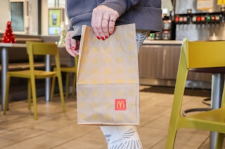 a person holding a mcdonalds bag