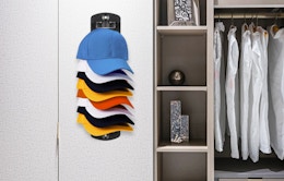 a hat organizer on a wall of a closet 