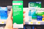 hand holding walgreens lens solution