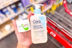hand holding cerave cleansing balm and facial cleanser above cvs shopping cart
