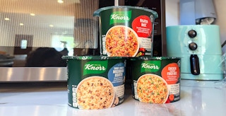 three varieties of knorr rice containers near microwave
