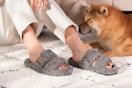 Woman wearing open-toe fuzzy slippers.
