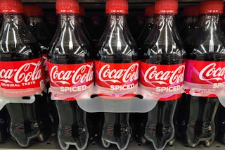 coca cola soda six pack on store shelf