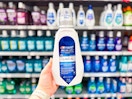Crest Mouthwash held up in front of other mouthwash brands in Walmart store