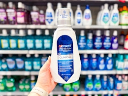 Crest Mouthwash held up in front of other mouthwash brands in Walmart store