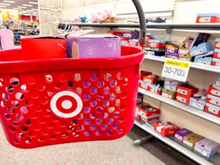hand holding a target basket in front of children's shoe clearance