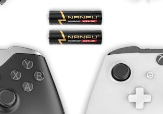 two batteries next to game controllers 