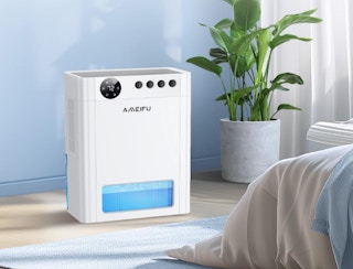 a dehumidifier next to a bed in a room