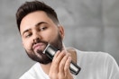 a man using a beard trimmer