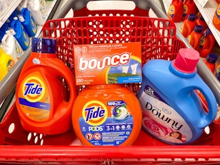 Bounce dryer sheets, Tide pods, Tide liquid laundry detergent, and Downy liquid fabric condirioner together in a Target shopping cart
