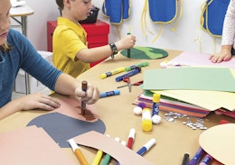 kids at a table making crafts with construction paper