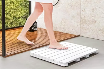 Lifestyle image of the  HONEY JOY bathmat used outside of a shower