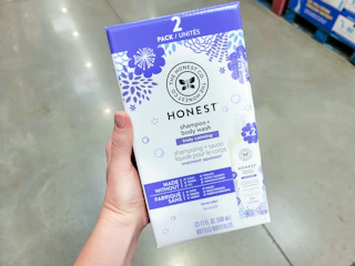 hand holding a 2-pack of honest lavender baby shampoo and body wash