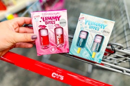 person placing covergirl gift sets in a cart