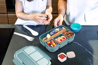 people eating out of green bento box