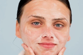 a woman washing her face with foaming face wash