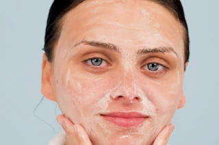 a woman washing her face with foaming face wash