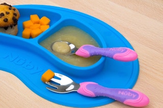 a purple and pink nuby utensil set with food