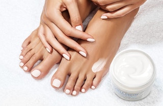 dry skin cream next to a pair of feet