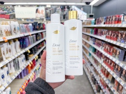 hand holding dove shampoos in walgreens aisle