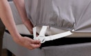 a bed sheet holder being put on a bed