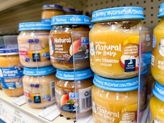 A variety of Gerber Natural for Baby baby food sitting on a store shelf.