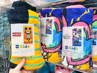disney beach towels on shelf