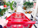 Target shopping cart being pushed down center aisle of home section in Target store