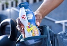a person putting a protein shake in their backpack