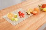 cutting board with chopped up fruit on it