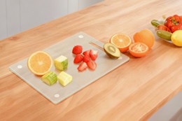 cutting board with chopped up fruit on it