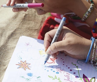 A person drawing with colorful markers