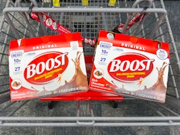 two packs of boost nutrition shakes in a shopping cart